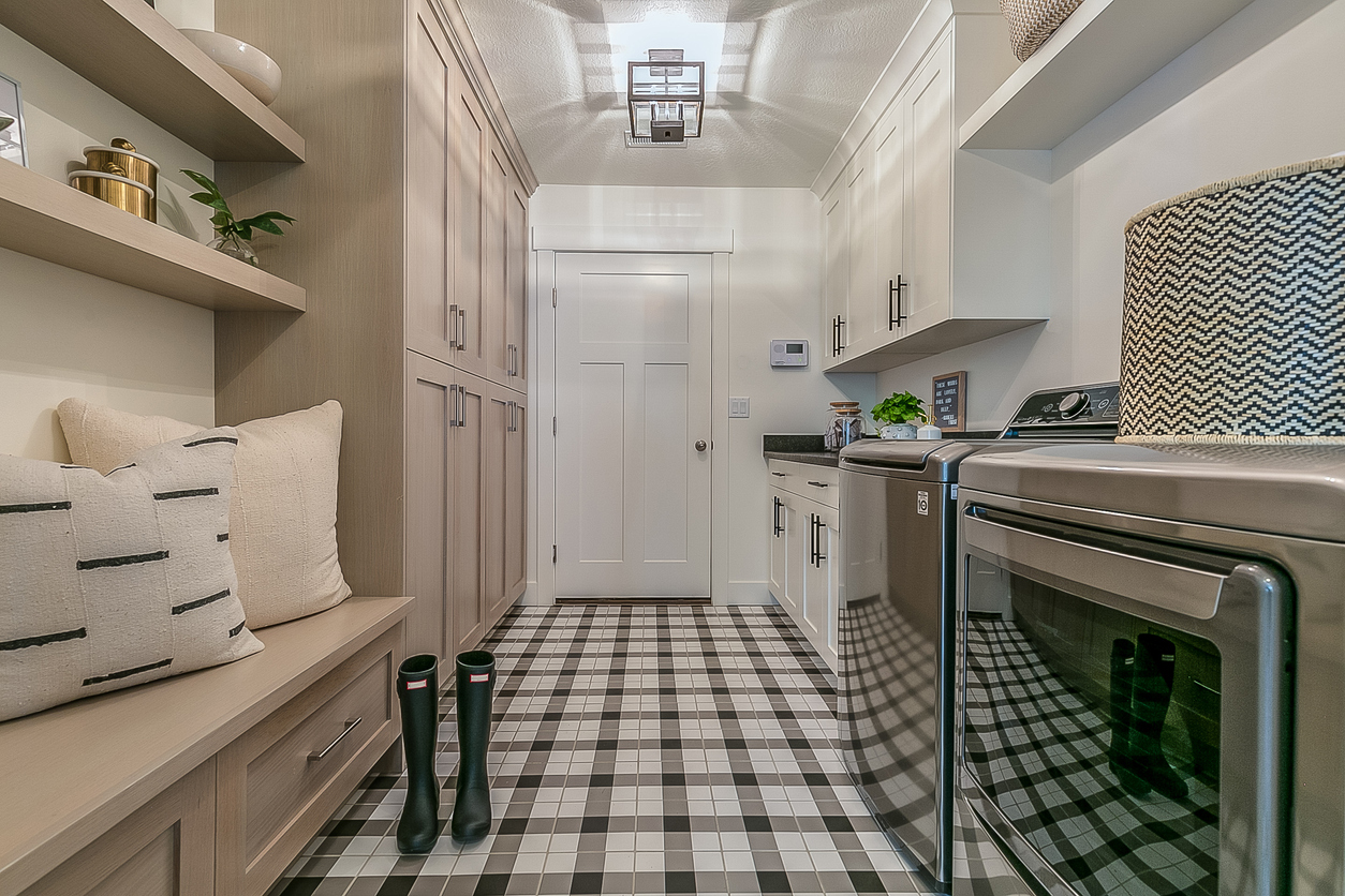 Rain boots and gingham decorated flooring in boot room